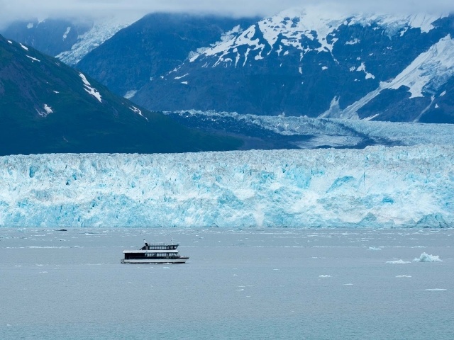 Tour boat passes along Hubbard Glacier